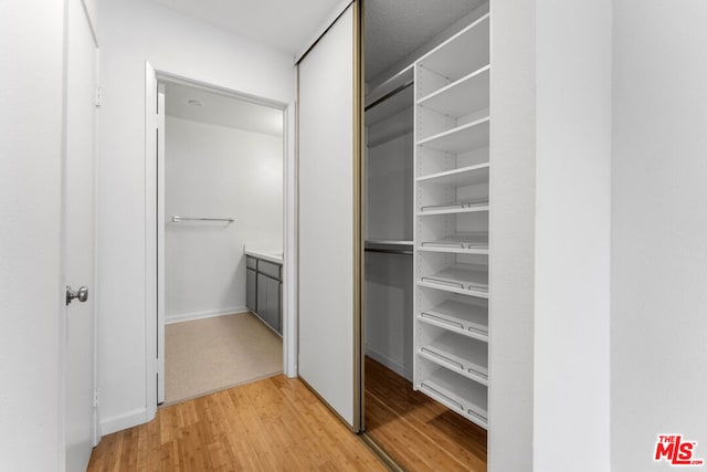 spacious closet with hardwood / wood-style floors