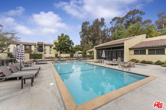 view of swimming pool with a patio