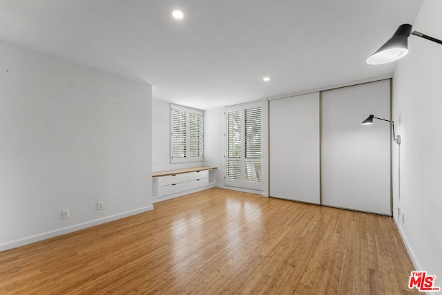 unfurnished bedroom with light hardwood / wood-style floors