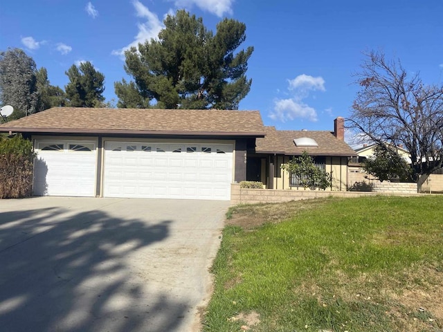 view of front of house with a front lawn and a garage