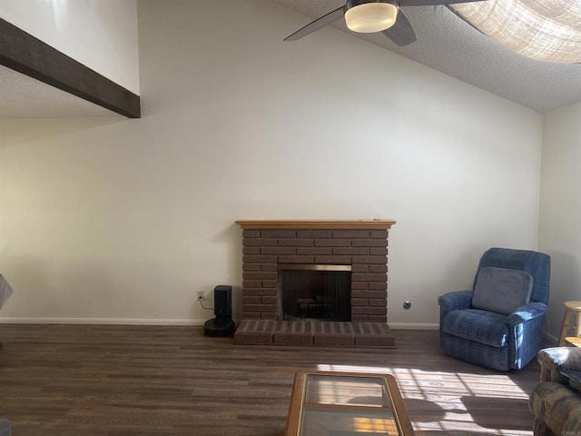 living room featuring ceiling fan, a textured ceiling, lofted ceiling, and a brick fireplace