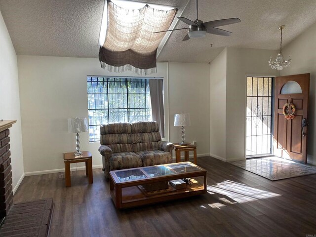 living room with lofted ceiling, dark wood-type flooring, and a textured ceiling