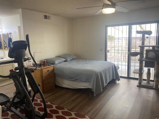 bedroom with ceiling fan, wood-type flooring, access to outside, and a textured ceiling