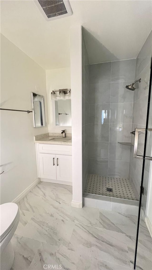 bathroom with a shower with shower door, toilet, and vanity