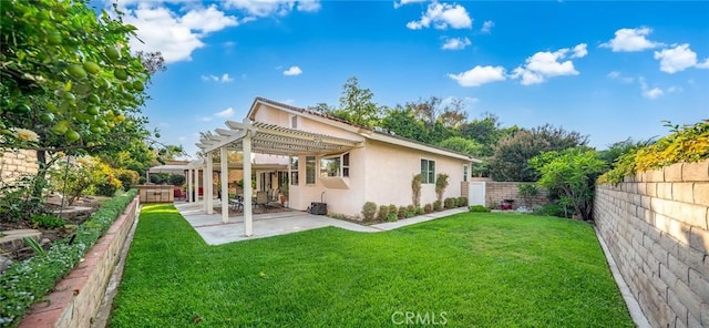 back of house featuring a pergola, a patio area, and a yard