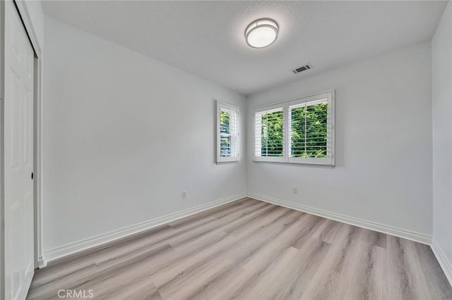 spare room featuring light wood-type flooring