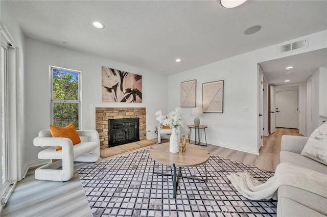 living room featuring light hardwood / wood-style flooring and a fireplace