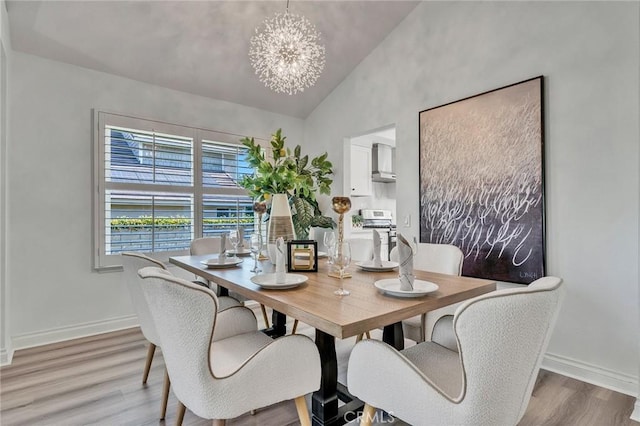 dining room featuring vaulted ceiling, a chandelier, and hardwood / wood-style flooring