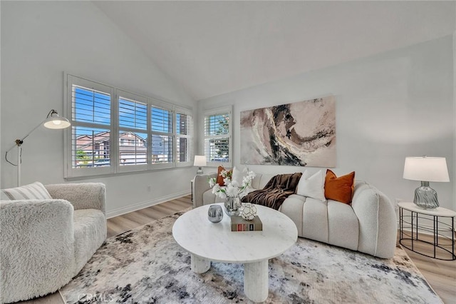 living room with hardwood / wood-style floors and high vaulted ceiling