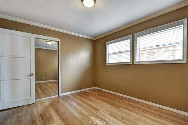 unfurnished bedroom featuring a closet, crown molding, and light hardwood / wood-style floors