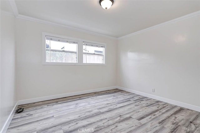 spare room with light hardwood / wood-style flooring and ornamental molding