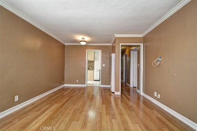 spare room with ornamental molding and light wood-type flooring