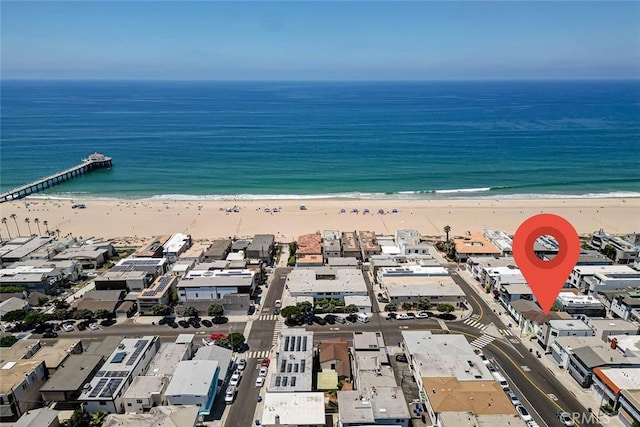 drone / aerial view featuring a water view and a beach view