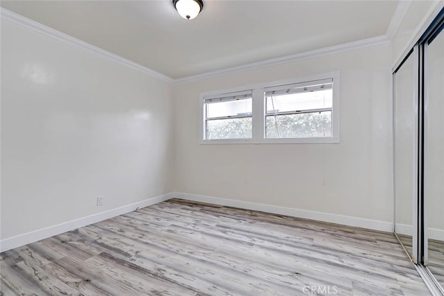 unfurnished bedroom featuring light hardwood / wood-style floors, a closet, and crown molding