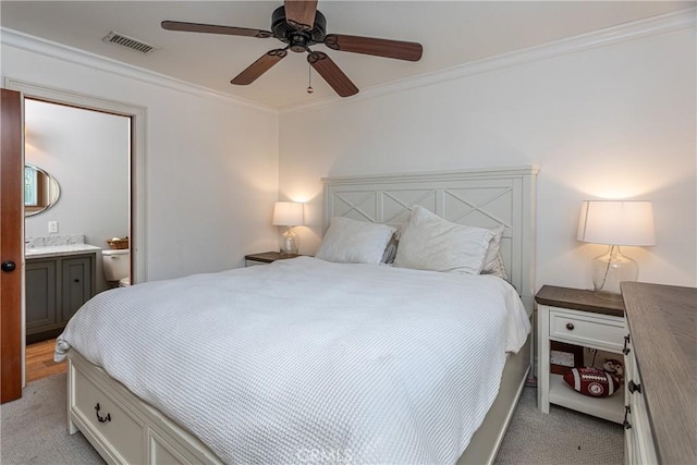 carpeted bedroom featuring ceiling fan, connected bathroom, and ornamental molding