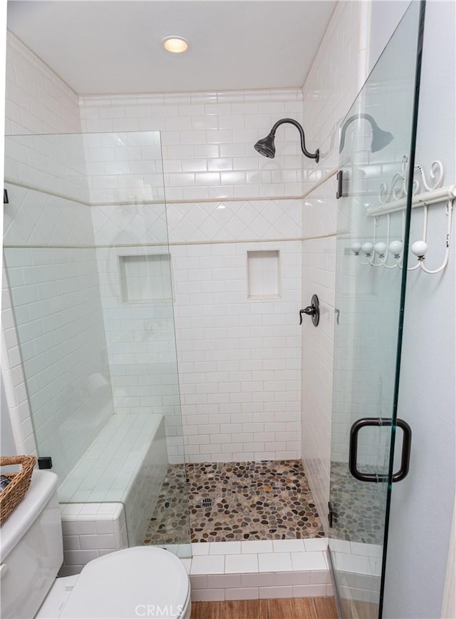 bathroom featuring toilet and walk in shower