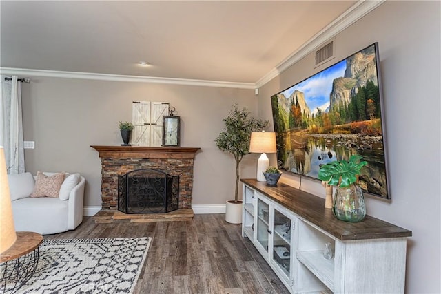 living room with dark hardwood / wood-style floors, crown molding, and a fireplace