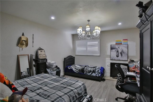 bedroom featuring light hardwood / wood-style flooring and a notable chandelier