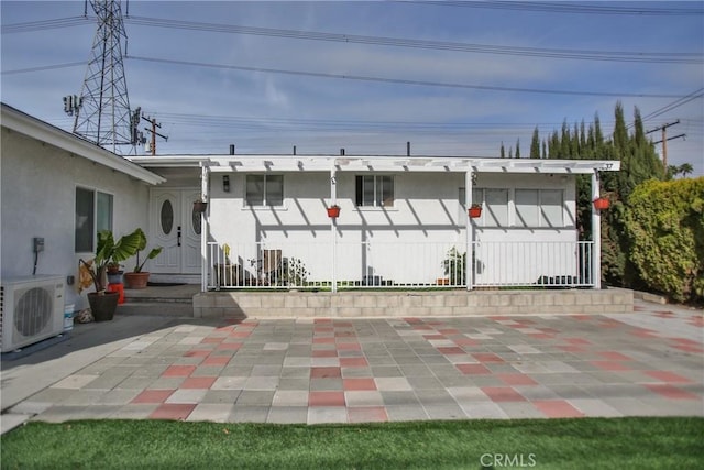 view of front of house featuring ac unit and a patio