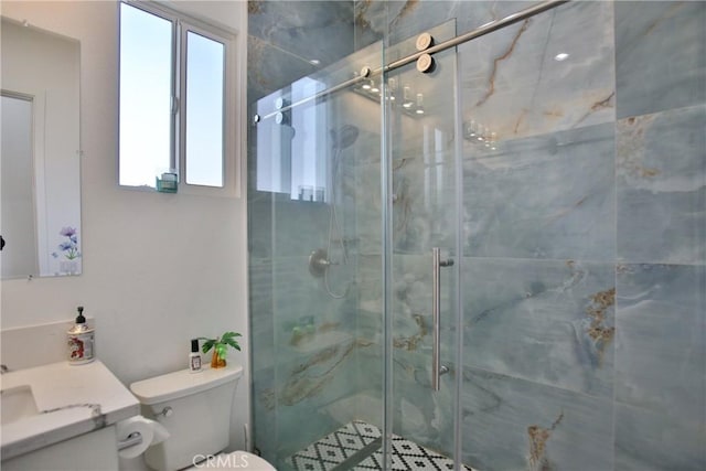 bathroom with a wealth of natural light, toilet, a shower with door, and vanity