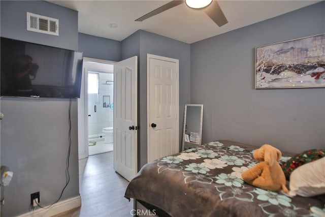 bedroom with ceiling fan, ensuite bath, and light hardwood / wood-style floors