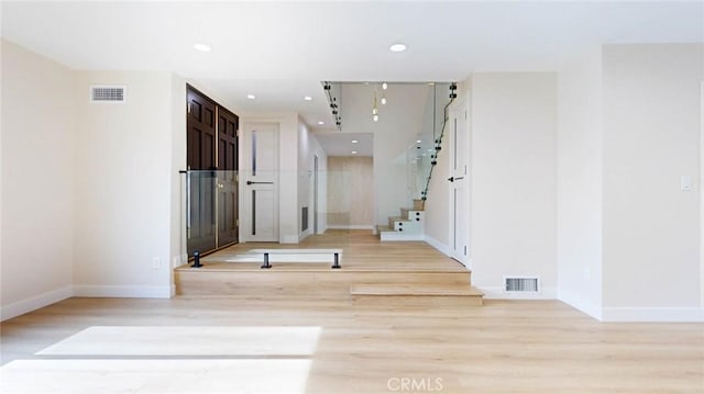 hall with light hardwood / wood-style floors