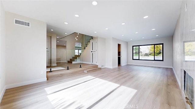 unfurnished living room with light wood-type flooring