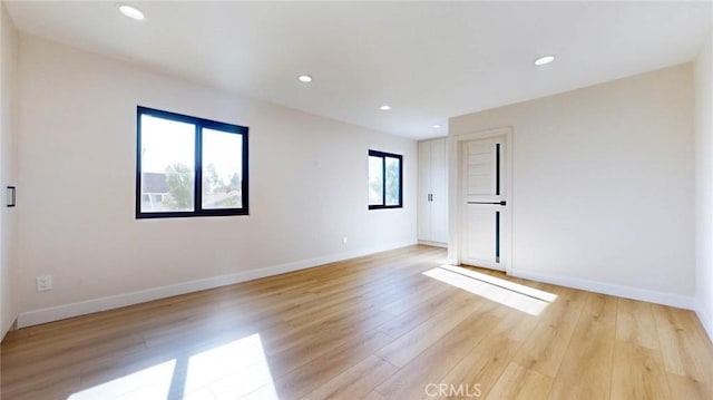 unfurnished room with light hardwood / wood-style flooring