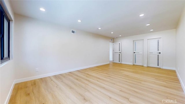 empty room with light hardwood / wood-style floors