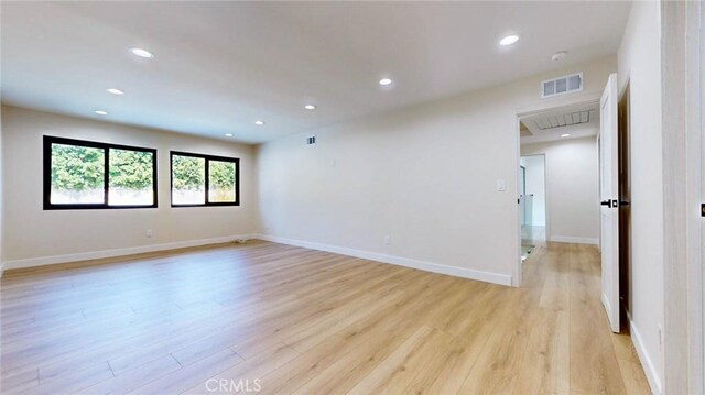 spare room with light hardwood / wood-style floors