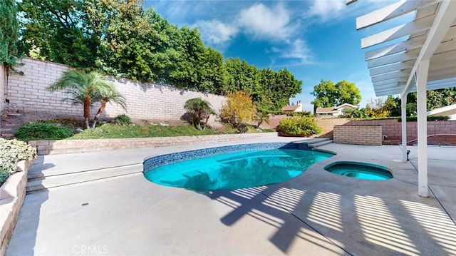 view of swimming pool featuring a patio area and an in ground hot tub