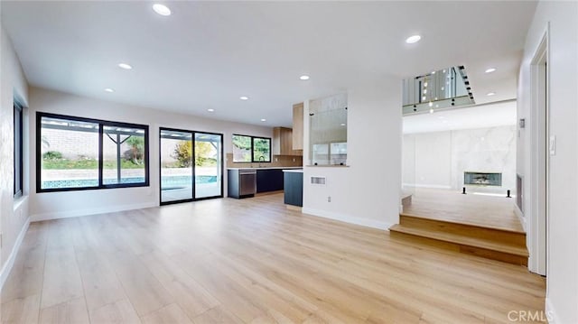 unfurnished living room featuring a fireplace and light hardwood / wood-style flooring