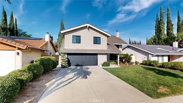 view of front of house featuring a front yard and a garage