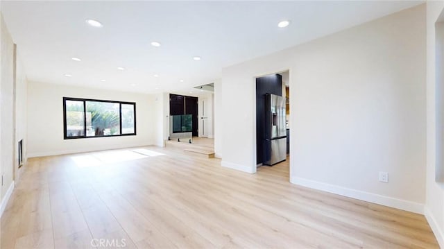 spare room with light hardwood / wood-style floors