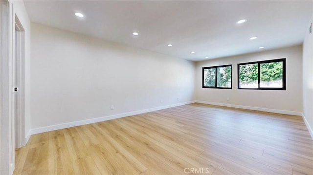 unfurnished room with light hardwood / wood-style flooring