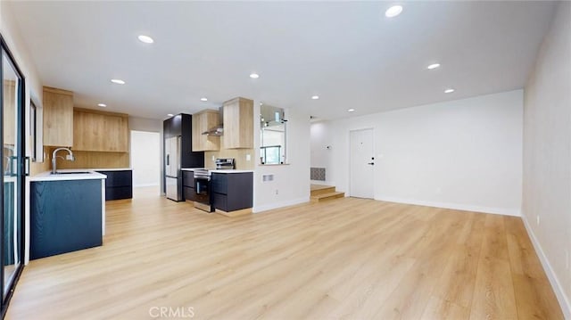 kitchen featuring built in fridge, sink, stainless steel range with electric stovetop, light hardwood / wood-style floors, and light brown cabinets