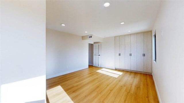 unfurnished bedroom featuring light wood-type flooring