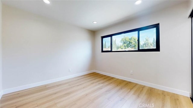 spare room with light wood-type flooring