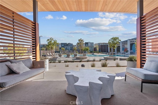 view of patio with an outdoor living space and a community pool