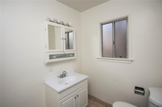 bathroom featuring vanity, tile patterned floors, and toilet