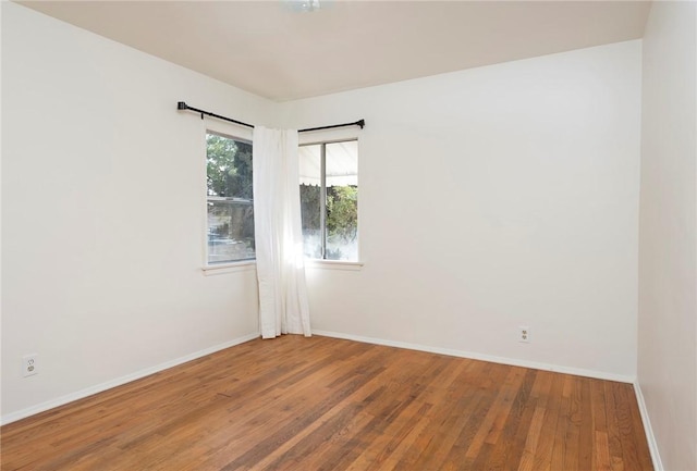 unfurnished room featuring wood-type flooring