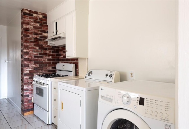 washroom with washing machine and clothes dryer and light tile patterned floors