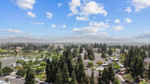 birds eye view of property with a water and mountain view