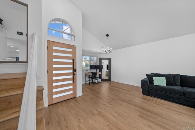 entryway featuring high vaulted ceiling and light wood-type flooring