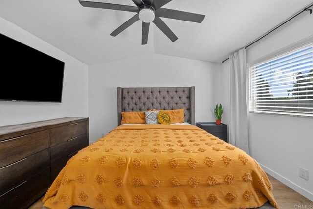 bedroom featuring ceiling fan, vaulted ceiling, and hardwood / wood-style flooring