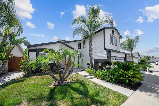 view of front of house with a front yard and a garage