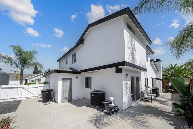 back of property featuring a patio area and central AC