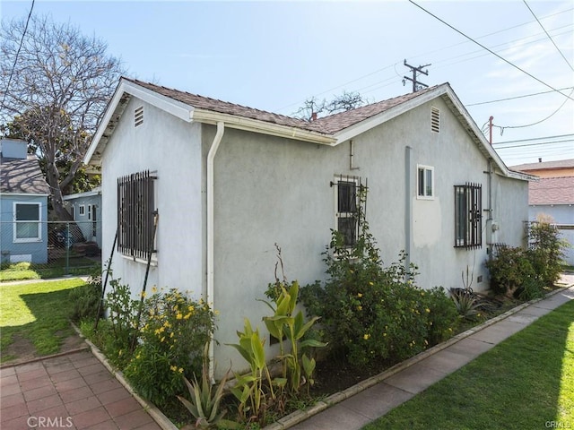 view of property exterior featuring a lawn