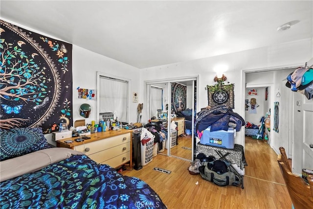 bedroom with a closet and hardwood / wood-style floors