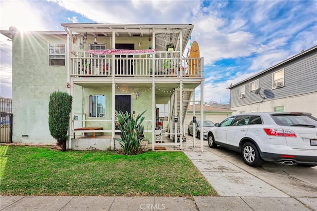 view of front of property with a front lawn and a balcony